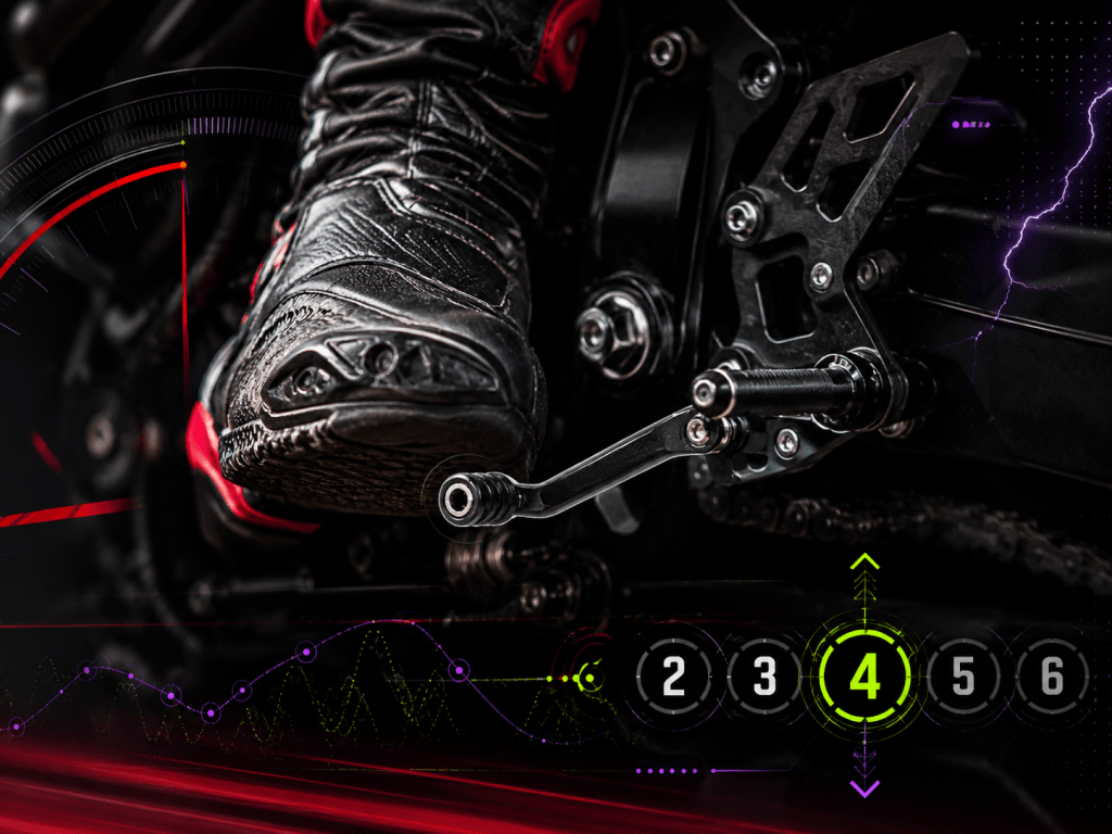 Close-up of a motorcycle rider’s boot on the shift lever with gear selection telemetry overlays.